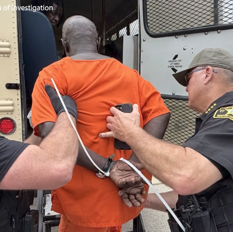 Inmate being taken into custody.